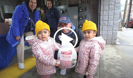 children holding a frozen turkey at the Newark Food "Farmacy"